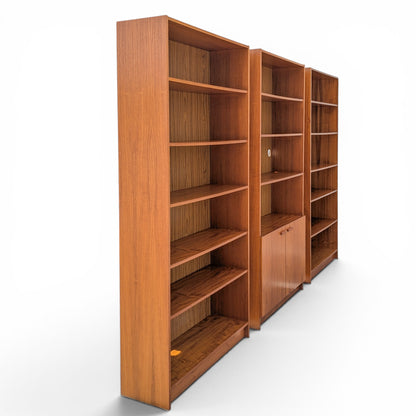 A trio of teak bookcases