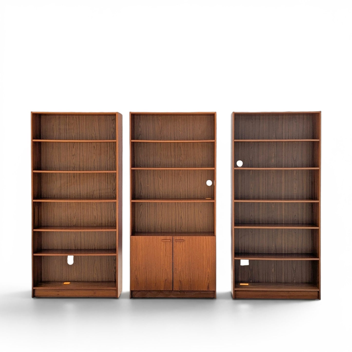 A trio of teak bookcases